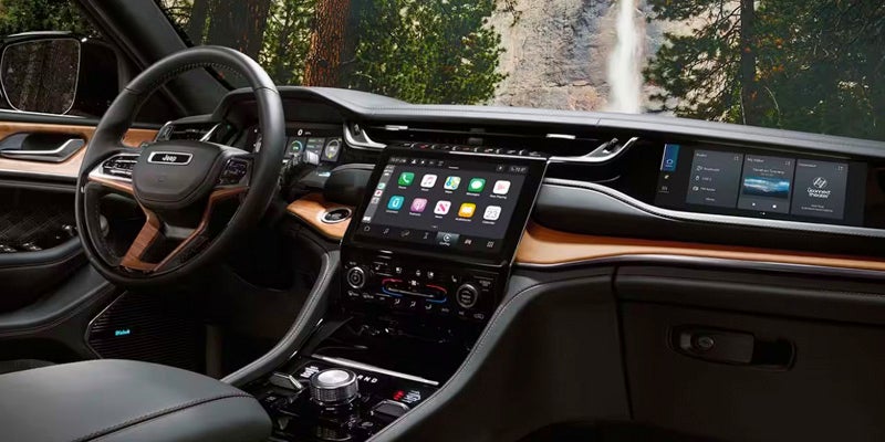 Jeep Grand Cherokee dashboard with a large touchscreen display and digital controls.