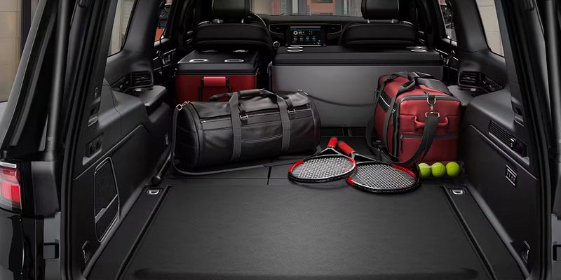 Large rear cargo space with luggage, sports equipment, and travel gear neatly stored.