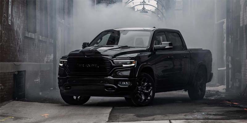 Black RAM 1500 pickup parked in a misty concrete tunnel.