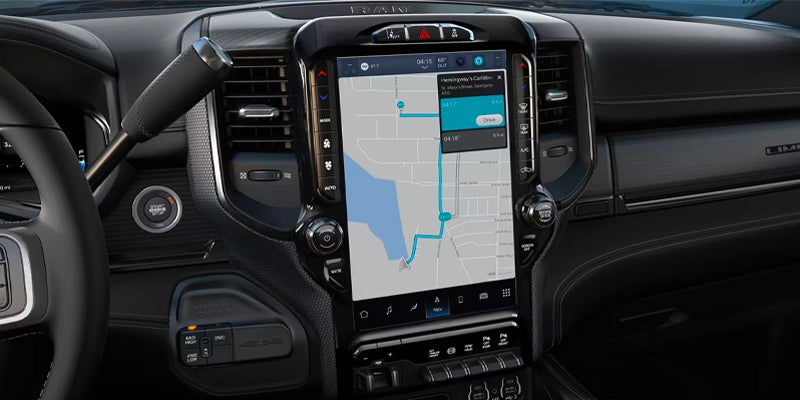 Large touchscreen display showing navigation and vehicle connectivity features in a Ram truck interior.