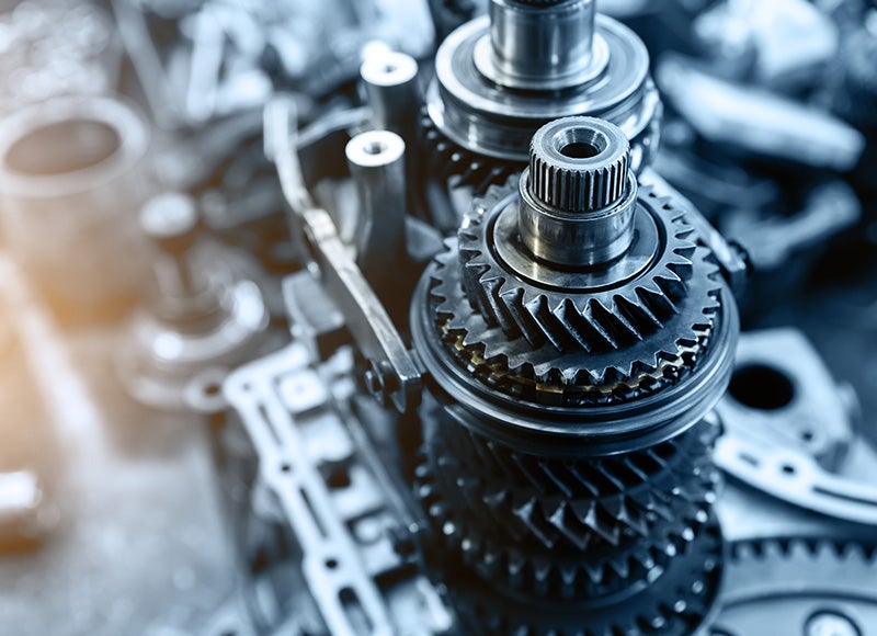 Close-up of transmission gears and internal drivetrain components during vehicle repair or maintenance.